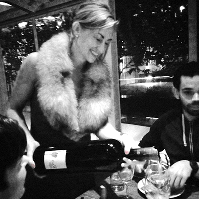 courtney pouring glos at PC holiday party 2015