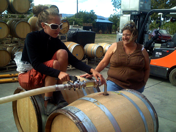 Carrie and LInda filling barrel with
          2007 LSB for fermentation and aging.